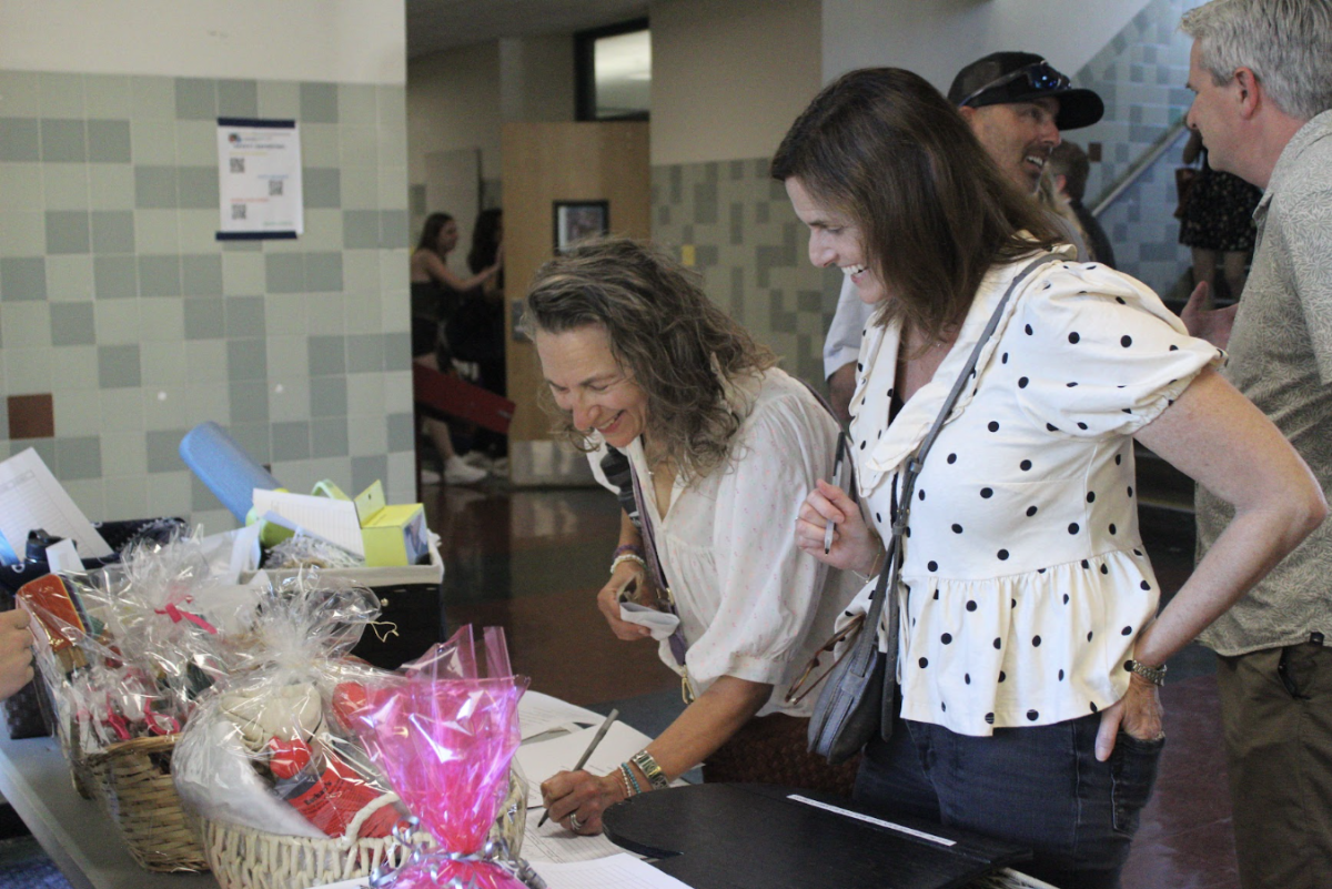 Leadership leads a blind auction with goods for any parent who purchases a basket full of goods.